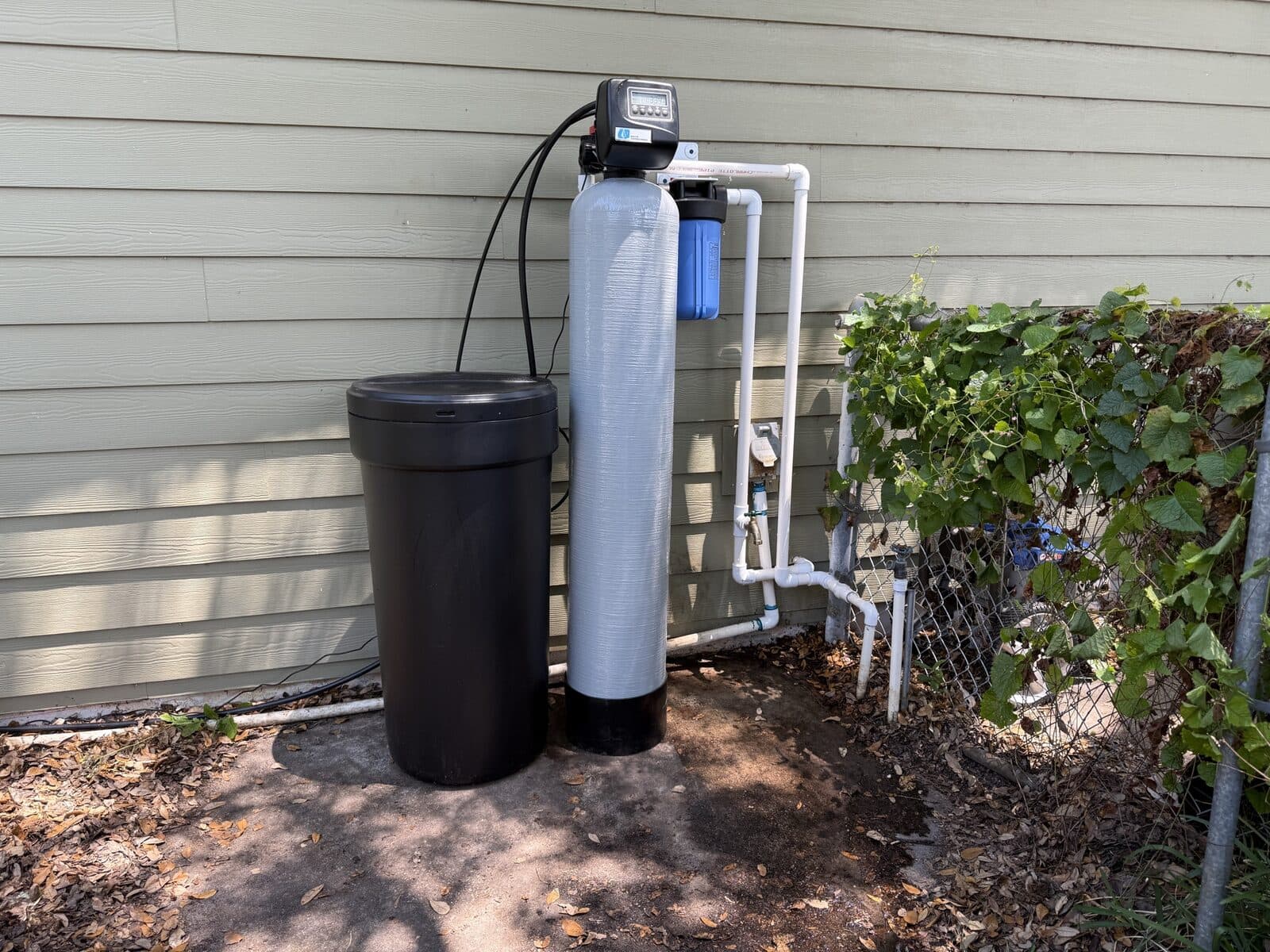 Outdoor whole-home softener and carbon tank installed at the main service line of a Burbank home
