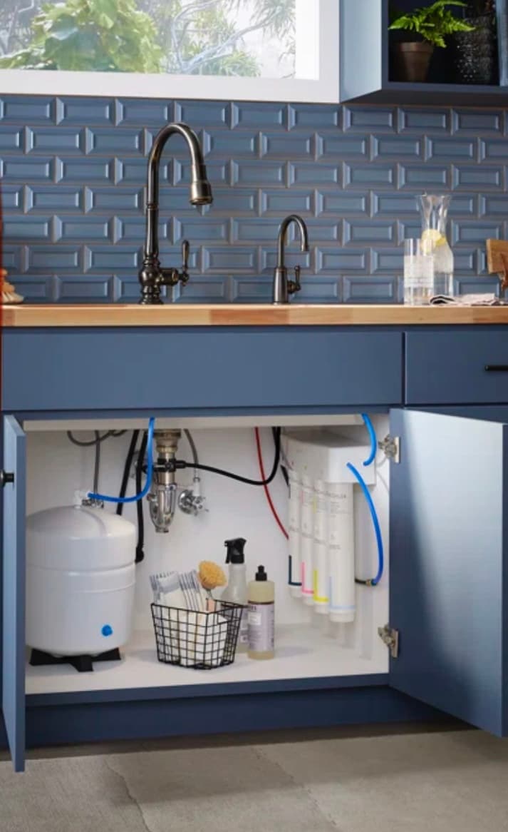 Reverse osmosis system mounted neatly under a kitchen sink