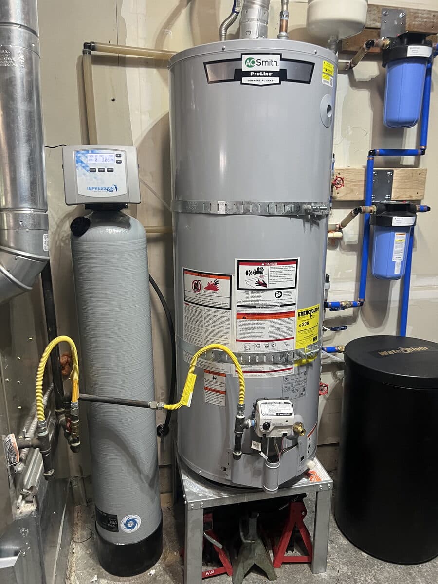 Standard tank water heater installed with a whole-house system in a Rancho Cucamonga garage