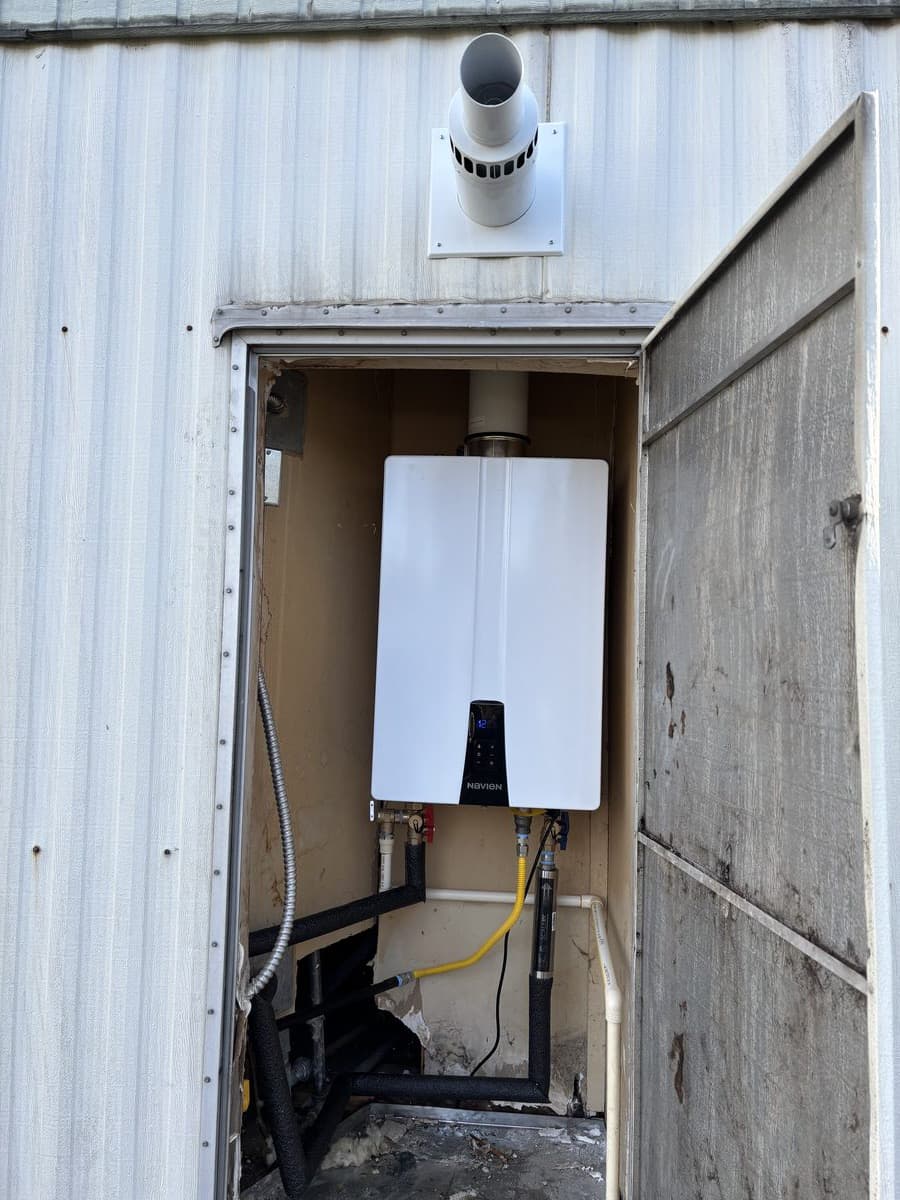 Tankless water heater installed in tight utility space at a San Bernardino home