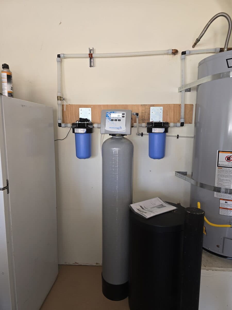 Whole-home softener with pre- and post-sediment filters installed in an Irvine garage