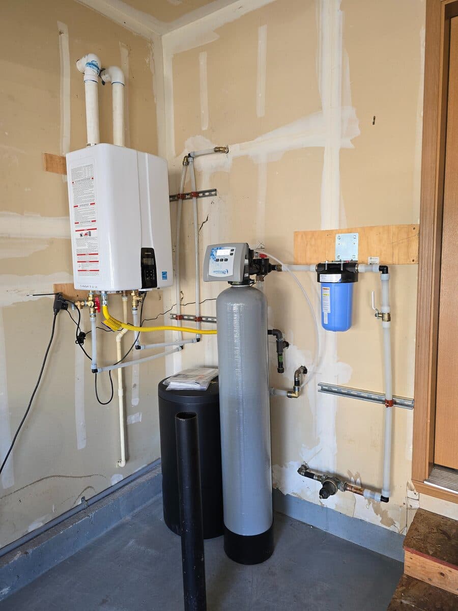 Whole-house filtration paired with a new tankless water heater in a Mission Viejo garage